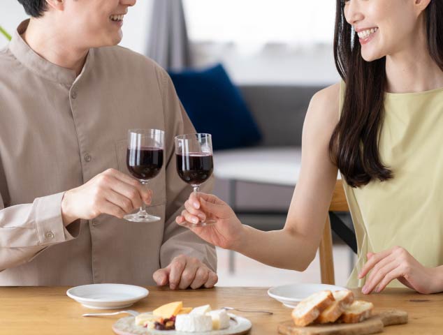 ダイニングテーブルで乾杯しているカップル
